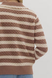 Brown and beige striped sweater on a plain background