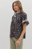 Woman wearing a floral blouse with a plain background