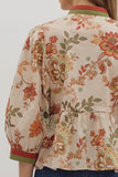 Floral patterned blouse with a neutral background