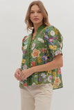 Woman wearing a green floral blouse against a white background