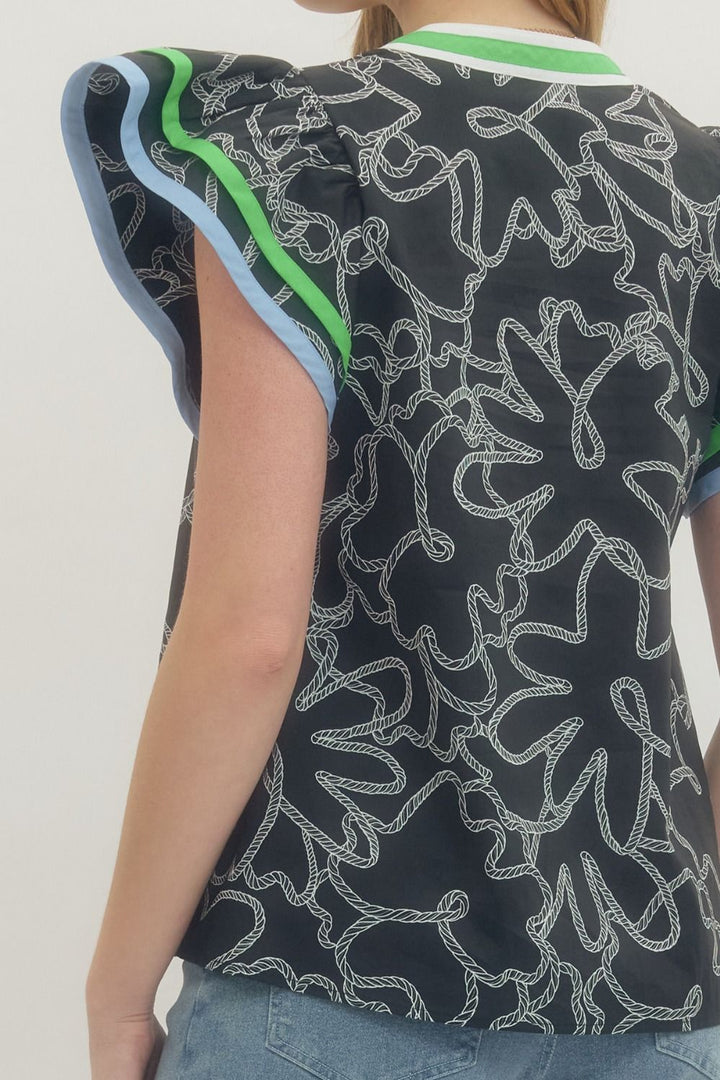 Person wearing a sleeveless top with abstract pattern on a plain background