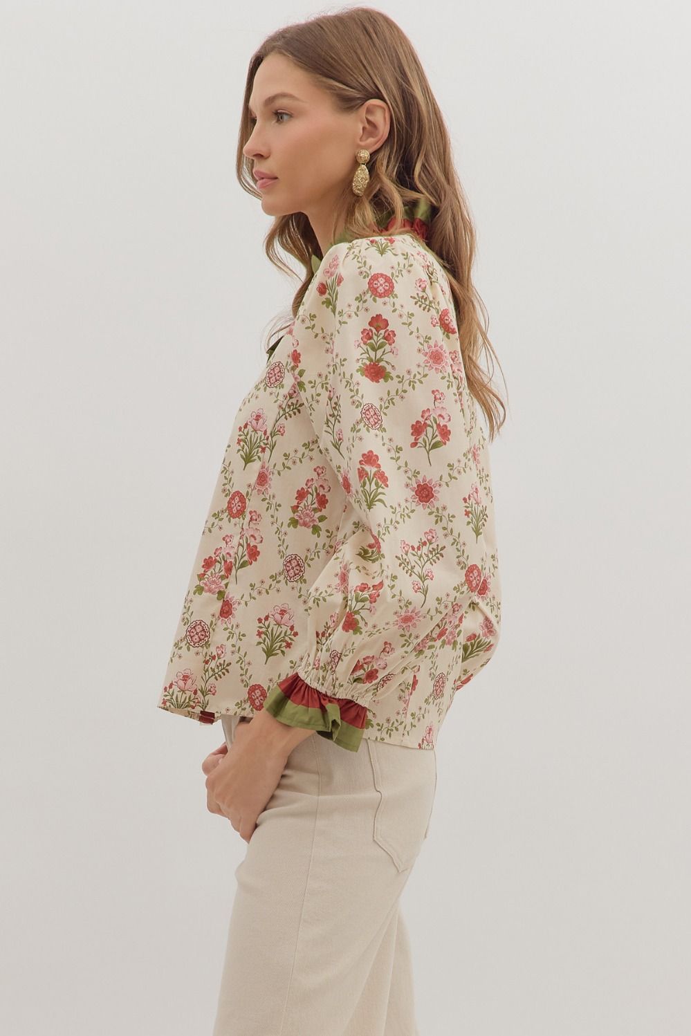 Woman wearing a floral blouse with a plain background