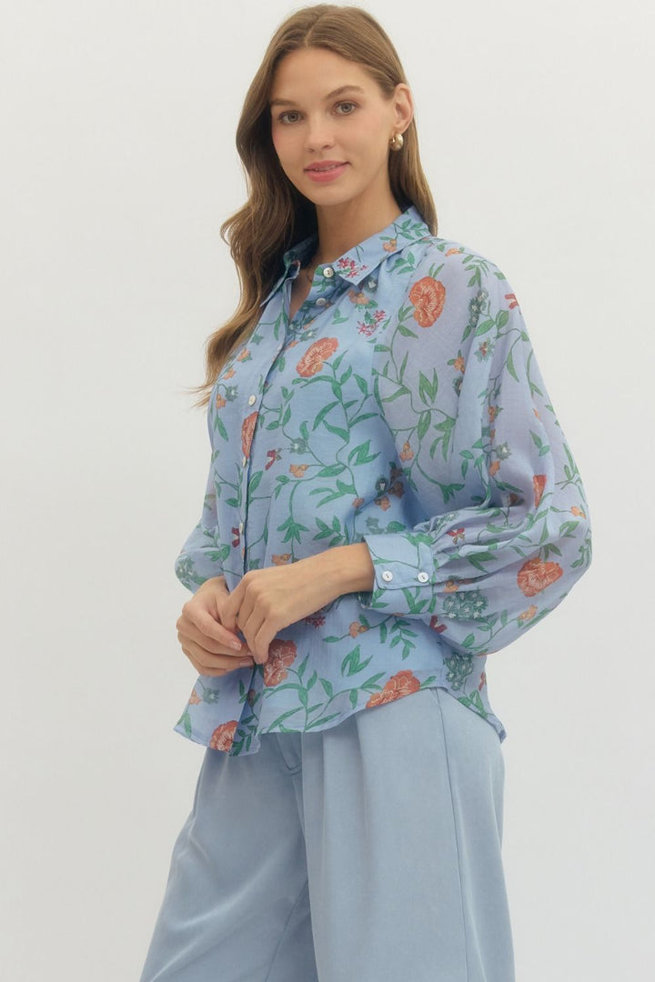 Woman wearing a floral blouse with a plain background
