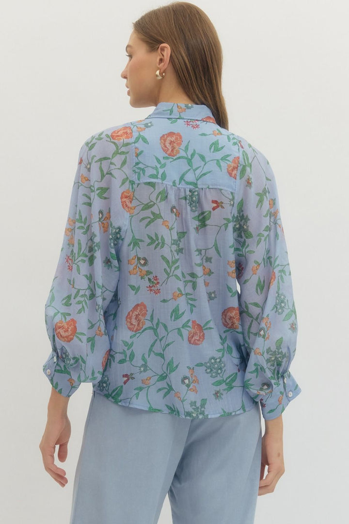Woman wearing a floral blouse with a plain background