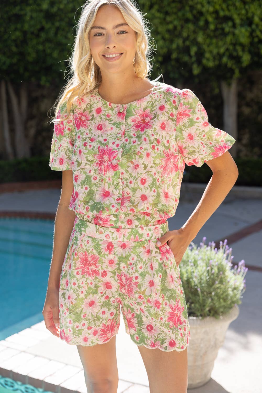 Woman wearing a floral outfit by a poolside