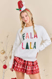 Person wearing a festive sweater with 'FALA LALA' text and plaid skirt on a beige background