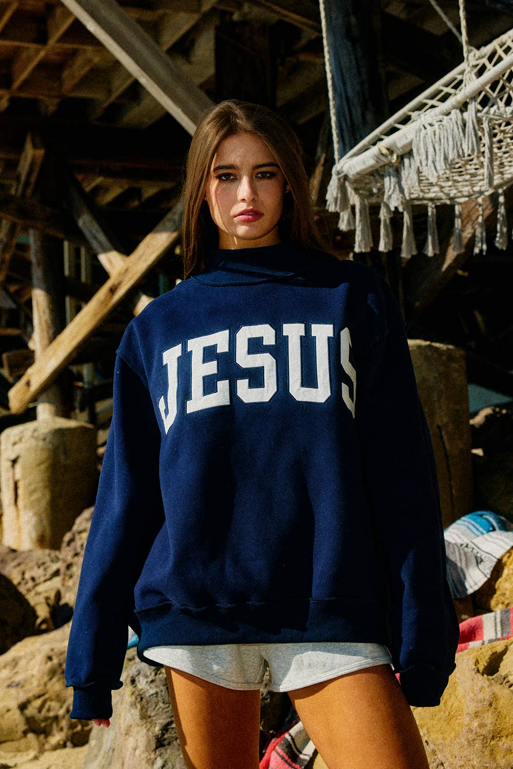 Person wearing a navy blue hoodie with &