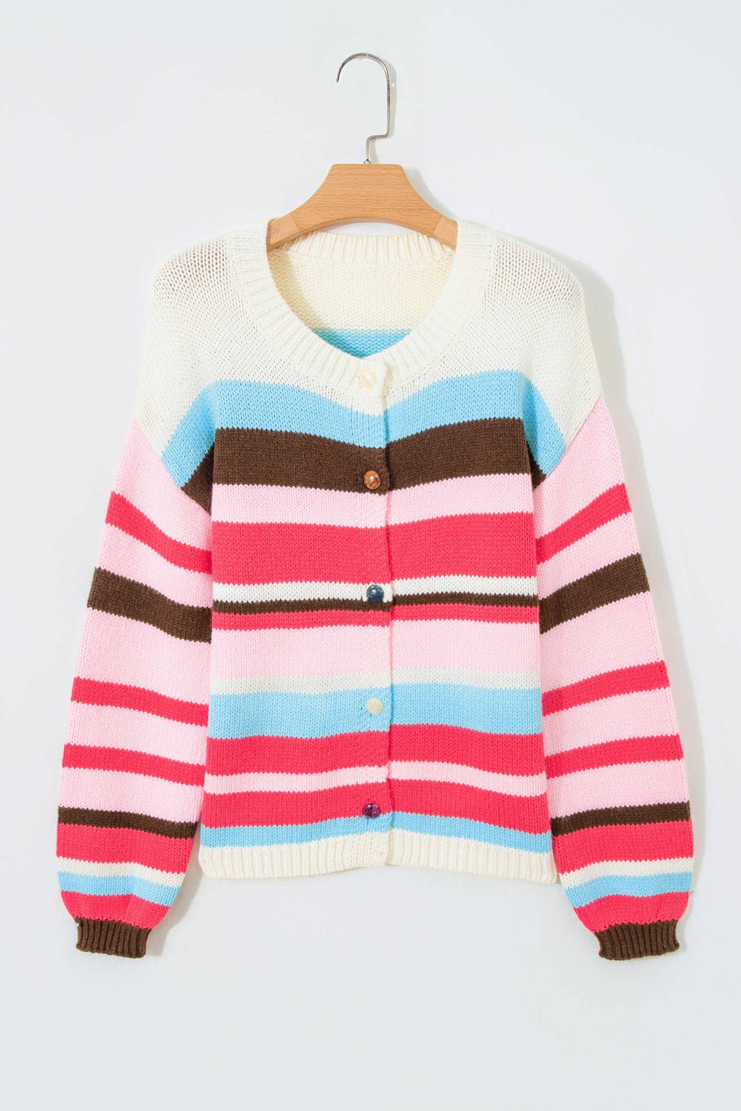 A multicolor striped knit cardigan sweater hanging on a wooden hanger against a plain light gray background. The cardigan features horizontal stripes of cream, light blue, pink, and brown, with a cream ribbed collar, cuffs, and hem, and three brown buttons on the front.